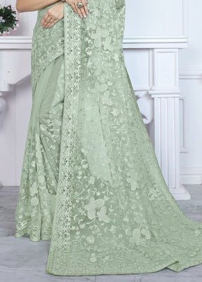 Pista Green Net Saree With Blouse Piece